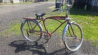 Side view of vintage 1960s Murray Jetfire X-64 boys/mens bicycle with red frame and white accents.