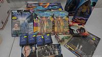 Full lot showing carded figures, magazines, boxed Klingon Attack Cruiser ship, VHS tape, accessories.
