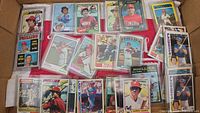 Box with multiple Larry Bowa baseball cards, mainly Philadelphia Phillies, some in sleeves and cases.
