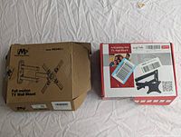 Two boxed small TV wall mounts, one brown box labeled Mounting Dream model MD243-1 and one red box labeled MaxTrek articulating arm mount.