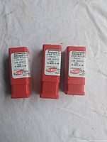 Three KEO #406 Woodruff keyseat cutters in red plastic protective cases, arranged horizontally on cloth surface.