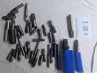 Photo of all milling cutters spread on a white surface, showing variety in size and shape