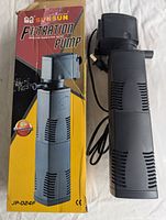 Sunsun JP-024F aquarium filtration pump next to its original box showing front and side views.