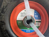 Close-up photo of the wheel assembly center with Arnold label and tire markings.