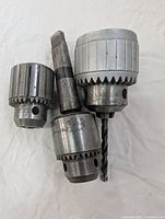 Three drill press chucks including two Jacobs 6A and one Golden Goose with #3 Morse Taper shown on white background.