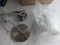 Photo of the brushed nickel ceiling canopy and cord wiring for the pendant light fixture.