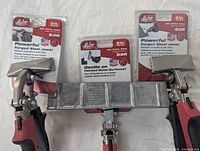 Three Malco sheet metal seamers S2R, S3R, and S9R in packaging laid flat with jaws visible