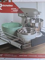 Front view of the closed box showing product image of pull-out organizer with bowls and mixer on it.