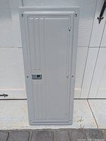 Closed front view of gray Siemens panel showing hinged door and vertical line design.