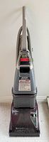 Full front view of Hoover SteamVac Ultra carpet cleaner with handle, hose, and base visible.