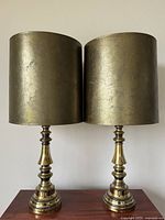 Pair of vintage brass table lamps side by side showing overall shape, size and shade color