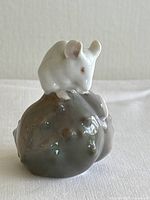 Front angle of the mouse on chestnut figurine showing mouse's front and chestnut details.