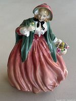 Front view of the Royal Doulton Lady Charmian figurine showcasing the detailed facial features, clothing and bouquet of flowers.