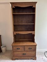 Front view of vintage two-piece tall wooden bookcase cabinet with adjustable shelving and drawers