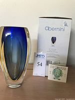 Front view of the oval Abernini vase with original box and tags visible.