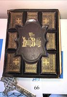 Bible cover and crucifix laid flat showing exterior design and included crucifix.