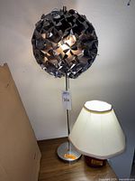 Both lamps together showing the full view of the silver geometric shade lamp and the beige fabric shade lamp.