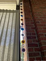 Full length of sun catcher hanging in window.