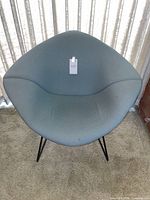Front view of diamond chair showing aqua grey cushion and black wire frame