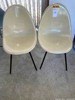 Front view of both chairs side by side showing shell shape and leg style