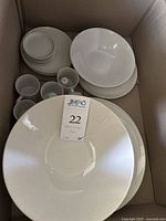 Full lot of white Schmid Ironstone ceramic dishes arranged inside a cardboard box.