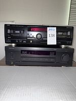 JVC cassette deck on top of Sherwood receiver showing front panels and controls