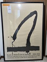 Front view of framed Robert Motherwell poster with abstract black brushstroke design and text below.