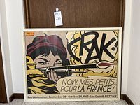 Full front view of framed poster showing artwork, frame and hanging wire reflected in glass