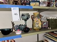 Shelf with various ceramic, glass and decorative items including the stamped England vase with chip
