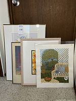 Four framed wall art prints stacked together, shows varying sizes and frames.