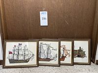 Four framed pieces with maritime and vintage transportation themes, arranged side by side against a wooden background.