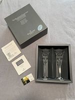 Set of two Waterford Crystal flutes in original box with accompanying documentation and box top.