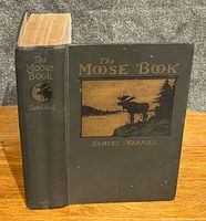 Front and spine view of the hardcover book showing embossed title and moose illustration on front cover.