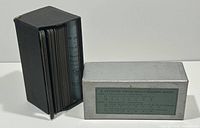 Photo showing the box containing the stereoview cards and the cards partially removed revealing black card stock edges.