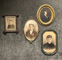 All four framed portraits displayed on wall