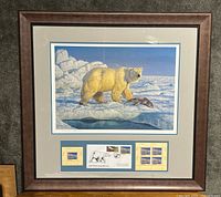 Framed print showing a standing polar bear on ice near a seal with stamps and FDC shown below.