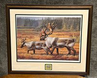 Framed print of Autumn Splendor by Mia Lane with two caribou in an autumn landscape and a mounted 1994 Newfoundland Plateau Stag stamp below the print.