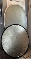 Oval Photoflex Lite Disc light reflector with silver and gold reflective sides, showing size and condition.
