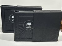 Two black 4-ring binders with WWF panda logos on front covers.