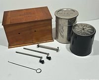 Photo showing wooden Kodak film tank box, two metal film developing tanks, four rods, and film items.