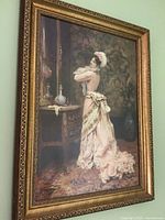 Close-up view of the painting and ornate golden frame, showing the detailed depiction of a Victorian lady in a formal dress near a mirror and table.