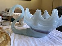 Milk glass swan bowl with curving neck and ruffled edge in white and opaque pastels