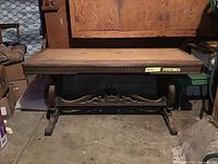 Full view of the vintage wooden desk showing top surface and carved legs.
