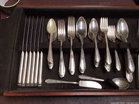 Full view of wooden box containing the entire vintage silverware set, showing forks, knives, spoons, and specialty utensils all organized in compartments