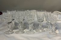Front view of all 10 Waterford cut crystal stemmed glasses, showing different sizes and detailed cut designs.