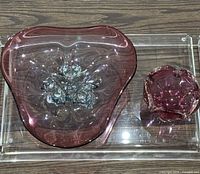 Top-down view of both Murano art glass bowls on clear tray displaying shape, size, and coloration
