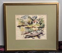Framed watercolour painting featuring a boat on a riverbank with a small house in the background, mounted with a green mat and gold frame.
