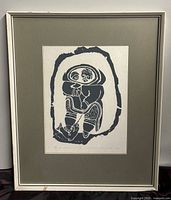 Full view of the framed Inuit block print showing the entire artwork and the frame.