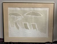 Full view of the framed embossed print showing the entire artwork and the frame with crack on the glass.