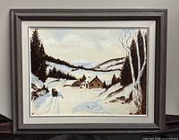 Framed oil painting showing snowy winter landscape with horse-drawn sleigh, trees, and houses.